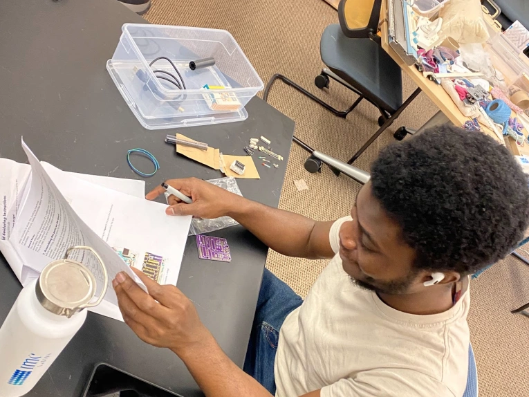 student works on knitting project